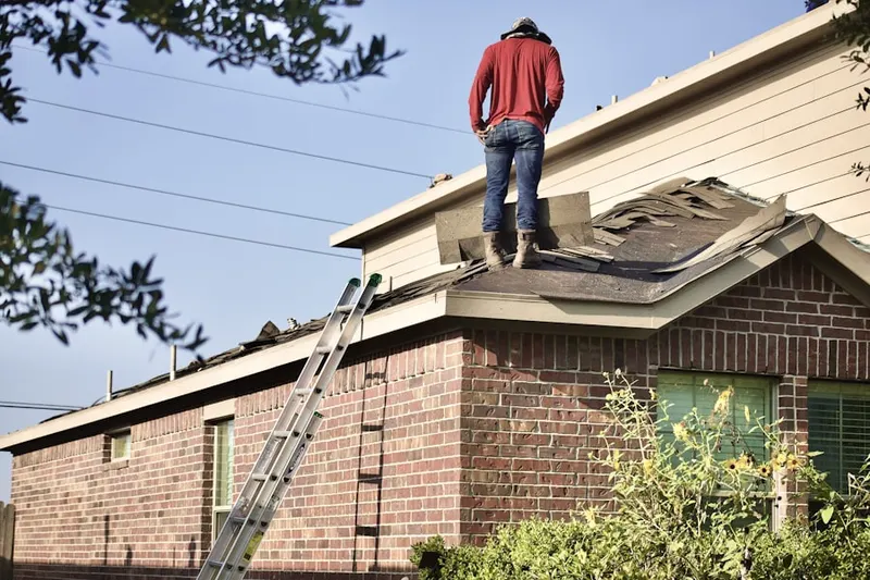 Professional roofer working on a residential roof in Burning Tree